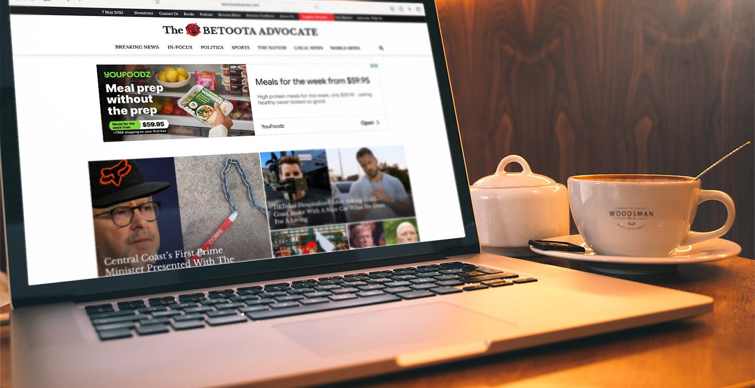 Betoota Advocate website on laptop with coffee